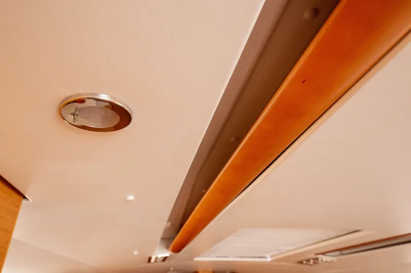  Yacht Photos Pics Ceiling detail of 2013 Jeanneau Sun Odyssey 439 yacht interior with wooden accents.