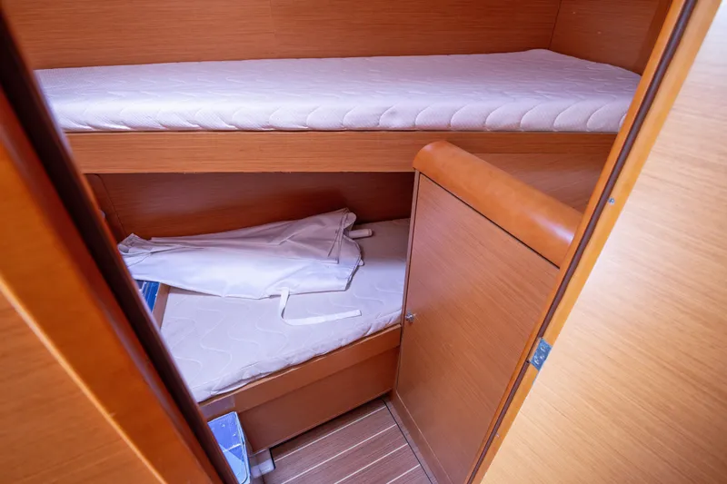  Yacht Photos Pics 2013 Jeanneau Sun Odyssey 439 cabin with wooden interior and bunk beds.
