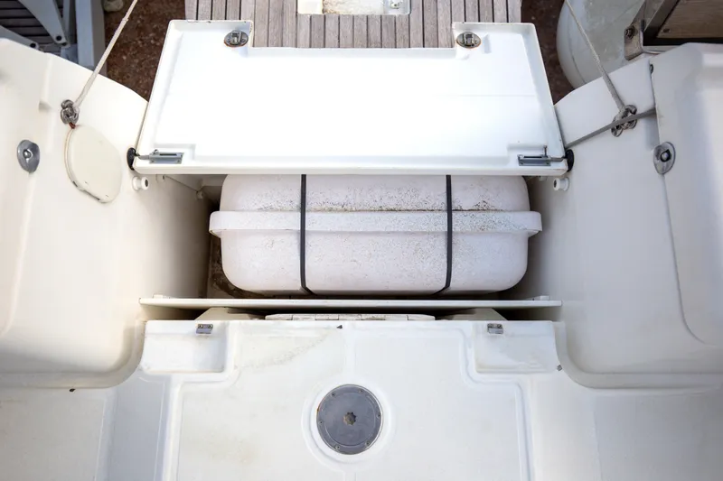  Yacht Photos Pics Storage compartment on a 2013 Jeanneau Sun Odyssey 439 sailboat, featuring a secured container.