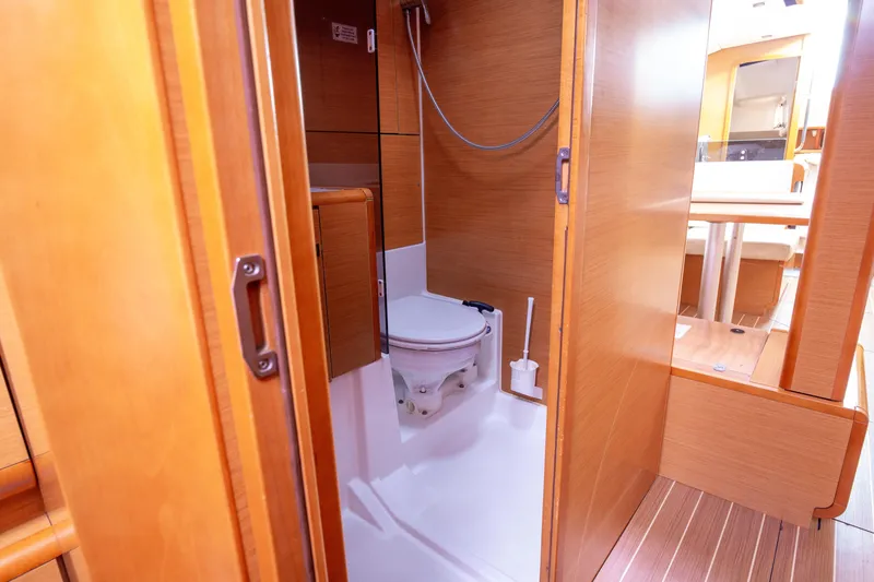  Yacht Photos Pics Interior of 2013 Jeanneau Sun Odyssey 439 yacht bathroom with wooden finish.