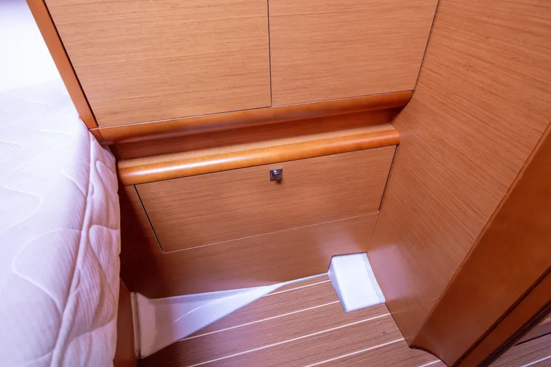  Yacht Photos Pics Interior cabin detail of 2013 Jeanneau Sun Odyssey 439 yacht, featuring wooden cabinetry.