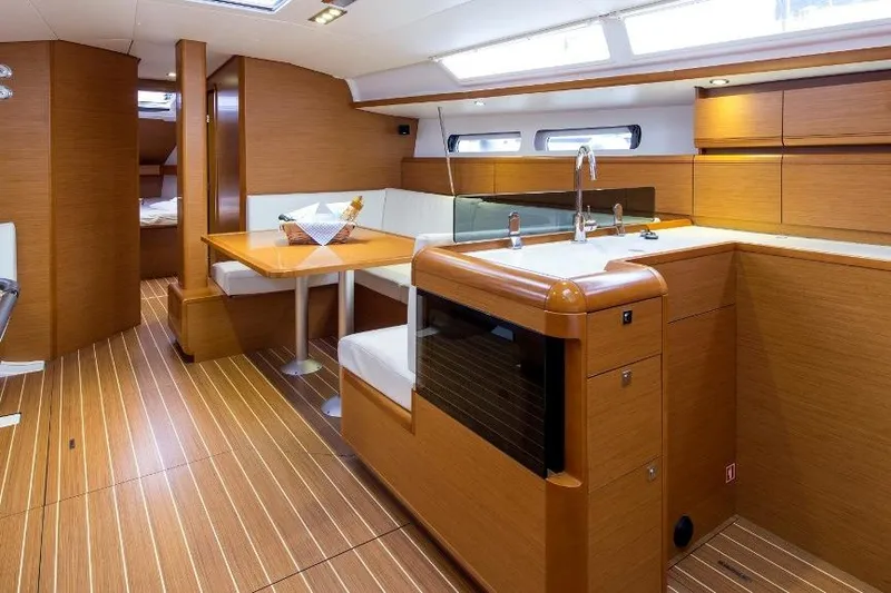  Yacht Photos Pics Interior of 2013 Jeanneau Sun Odyssey 439 yacht, featuring modern kitchen and dining area.