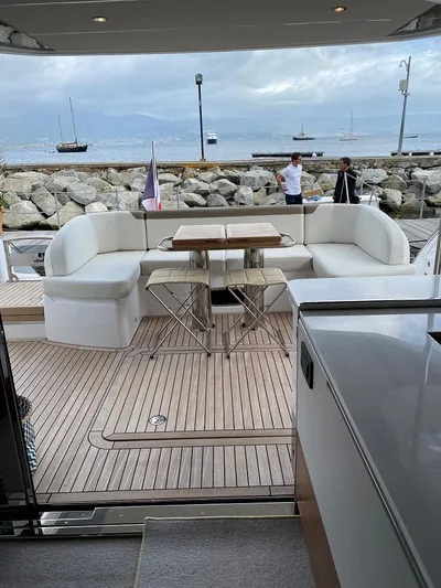 Panamera Yacht Photos Pics Luxurious 2020 Princess F62 yacht with elegant seating and scenic waterfront view.