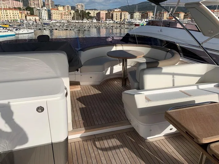 Panamera Yacht Photos Pics Luxurious 2020 Princess F62 yacht deck with elegant seating and scenic harbor view.