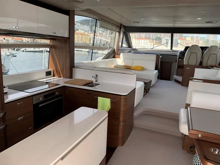 Panamera Yacht Photos Pics Luxurious interior of a 2020 Princess F62 yacht with modern kitchen and seating area.
