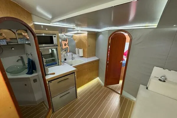 Joujou 2 Yacht Photos Pics 2002 Luhrs 38 Open yacht interior with modern kitchen and wood flooring.