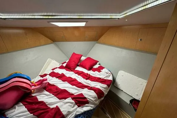 Joujou 2 Yacht Photos Pics 2002 Luhrs 38 Open cabin with striped bedding and wooden interior.