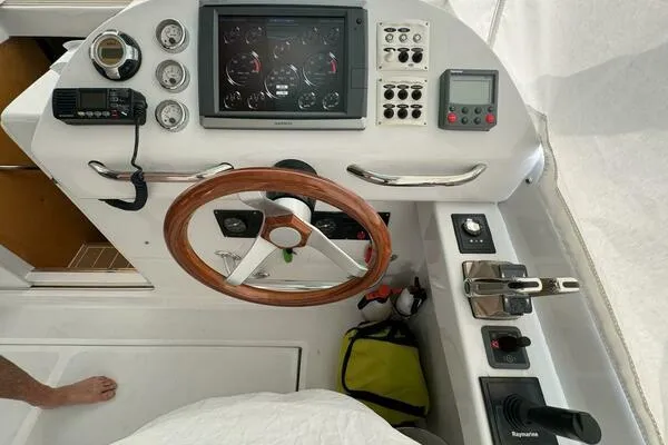 Joujou 2 Yacht Photos Pics Helm of 2002 Luhrs 38 Open boat with wooden steering wheel and navigation instruments.