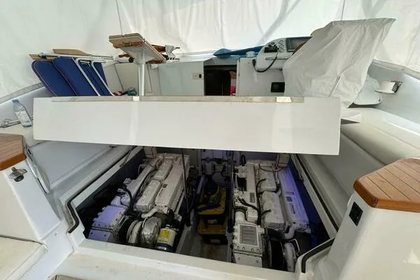 Joujou 2 Yacht Photos Pics Engine compartment of 2002 Luhrs 38 Open boat, showcasing dual engines and seating area.