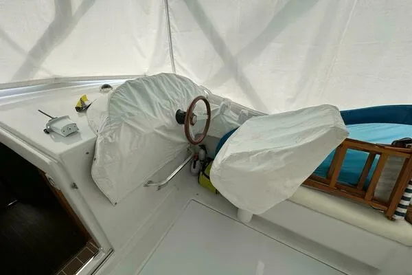 Joujou 2 Yacht Photos Pics 2002 Luhrs 38 Open boat helm with protective covers and wooden accents.