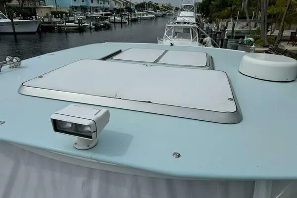 Joujou 2 Yacht Photos Pics 2002 Luhrs 38 Open boat deck with hatches and spotlight, docked in a marina.