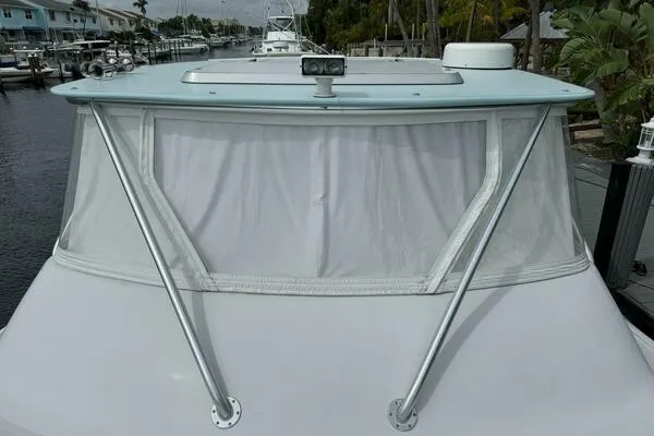 Joujou 2 Yacht Photos Pics 2002 Luhrs 38 Open boat with covered windshield and marina background.