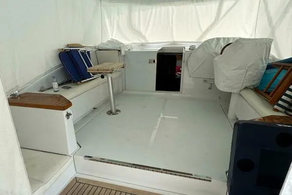 Joujou 2 Yacht Photos Pics 2002 Luhrs 38 Open boat interior with seating and covered equipment.