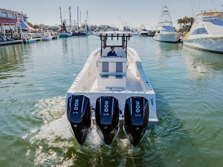  Yacht Photos Pics 2025 Invincible 36 Open Fisherman boat with triple 300 V8 engines in a marina.