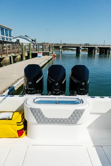  Yacht Photos Pics 2025 Invincible 36 Open Fisherman boat with triple Mercury engines docked at marina.