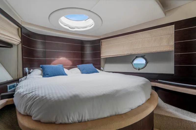  Yacht Photos Pics Luxurious bedroom interior of 2007 Azimut 68S yacht with round bed and porthole view.