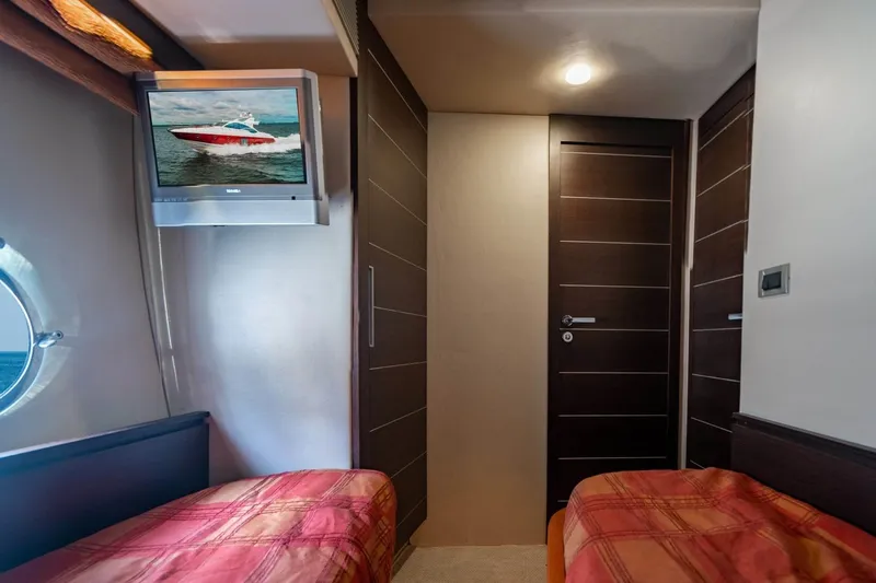  Yacht Photos Pics Interior of 2007 Azimut 68S yacht cabin with twin beds and wall-mounted TV.