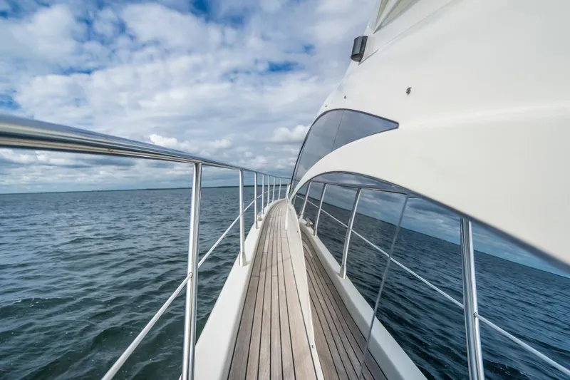  Yacht Photos Pics Side view of 2007 Azimut 68S yacht cruising on open water under a cloudy sky.