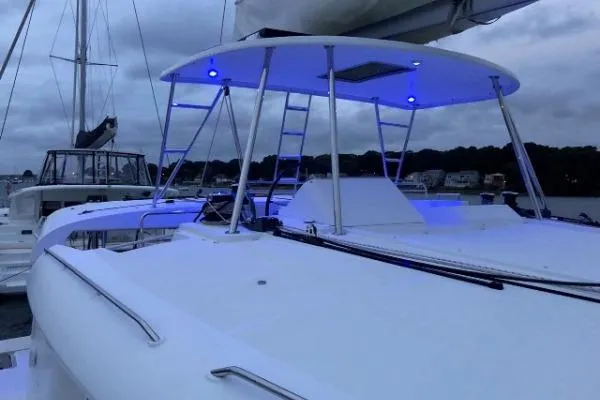 Whatif Yacht Photos Pics 2013 Lagoon 450 catamaran with blue LED lights, docked at a marina.