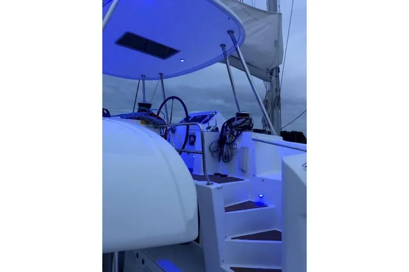 Whatif Yacht Photos Pics Sailing yacht Lagoon 450, 2013 model, featuring illuminated cockpit and helm station at dusk.