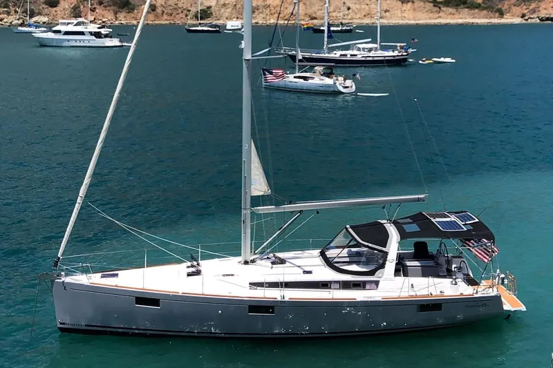 Shades Of Grey Yacht Photos Pics 2016 Beneteau Oceanis 473 sailboat anchored in a scenic bay with other boats.