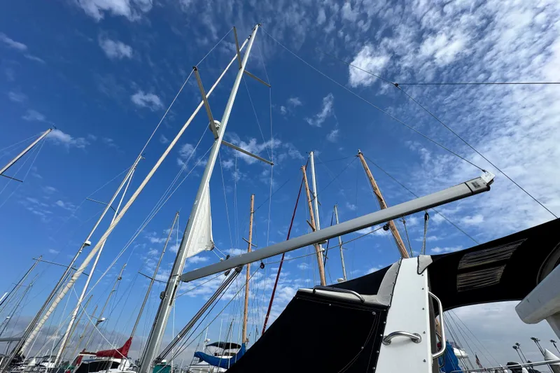 Shades Of Grey Yacht Photos Pics Sailboat masts against a blue sky, featuring a 2016 Beneteau Oceanis 48.