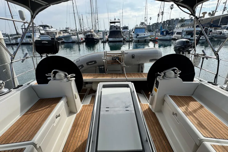 Shades Of Grey Yacht Photos Pics 2016 Beneteau Oceanis 48 yacht cockpit with wooden deck, docked in a marina.