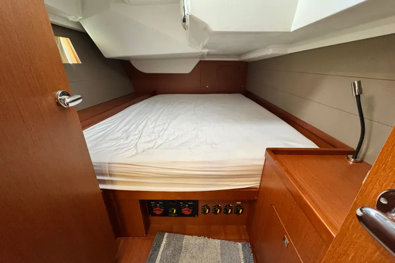 Shades Of Grey Yacht Photos Pics 2016 Beneteau Oceanis 48 cabin interior with bed, wooden finish, and reading light.