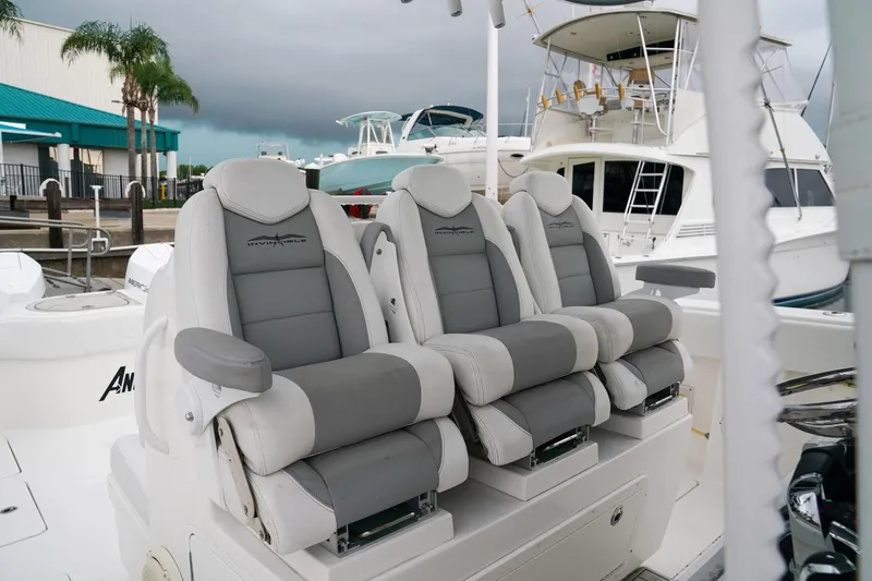 Another One Yacht Photos Pics Luxurious seating on 2019 Invincible 40 Catamaran, docked with other boats in background.