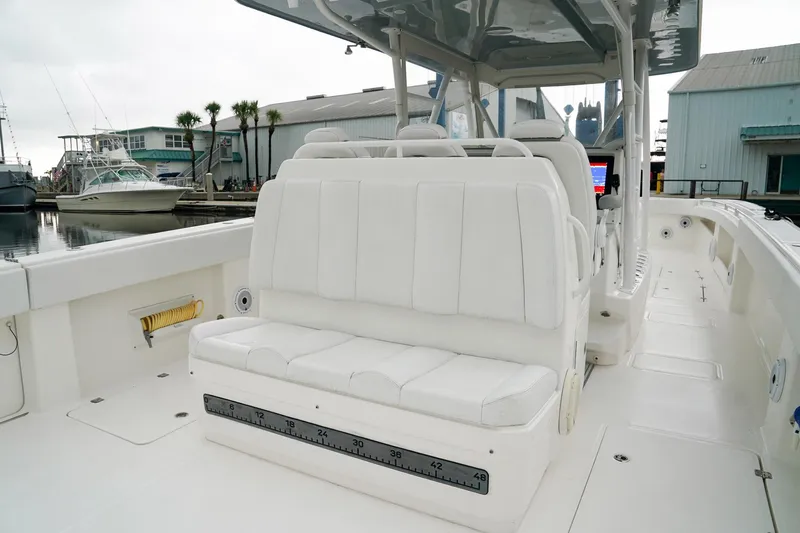 Another One Yacht Photos Pics 2019 Invincible 40 Catamaran with white seating, docked at a marina.