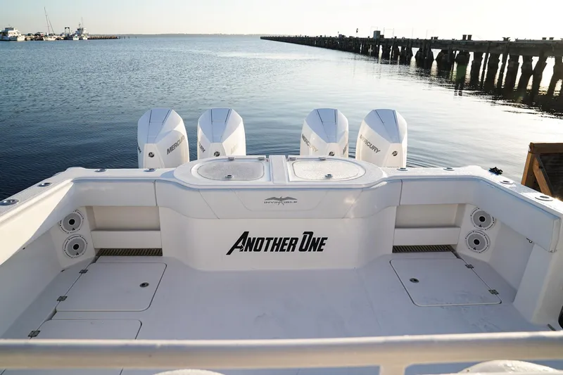 Another One Yacht Photos Pics 2019 Invincible 40 Catamaran with four engines, docked by a calm waterfront.