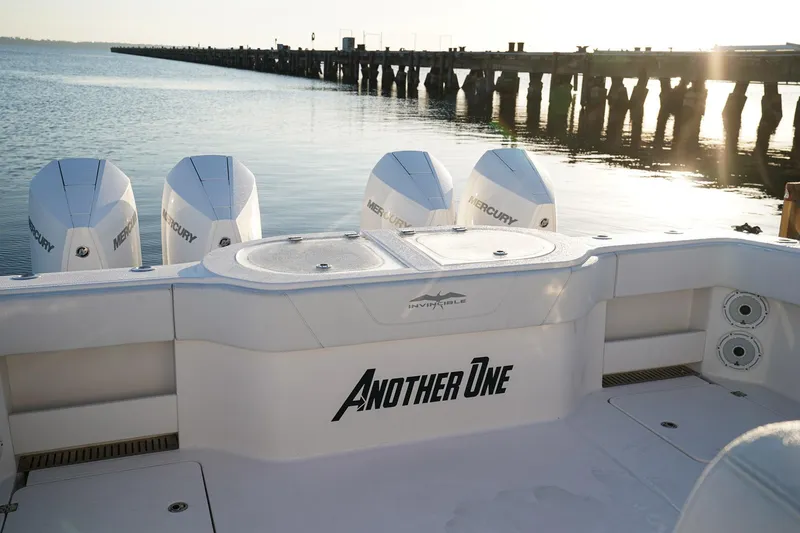 Another One Yacht Photos Pics 2019 Invincible 40 Catamaran with four Mercury engines docked by a pier at sunset.