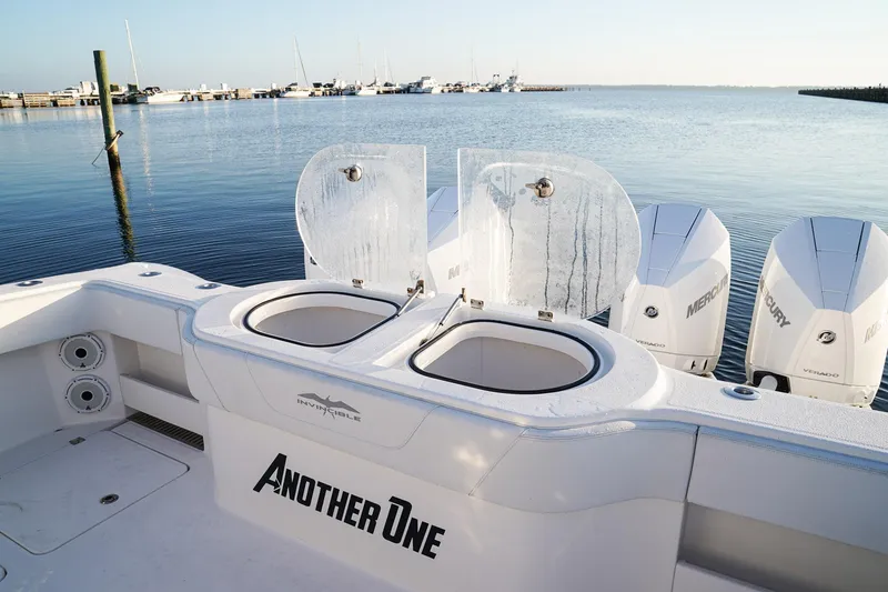 Another One Yacht Photos Pics 2019 Invincible 40 Catamaran with dual livewells and Mercury engines, docked by the sea.