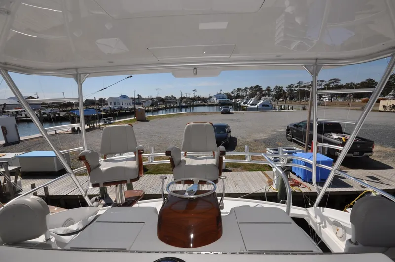  Yacht Photos Pics 2019 Viking 44 Convertible yacht interior with helm chairs, dockside view.