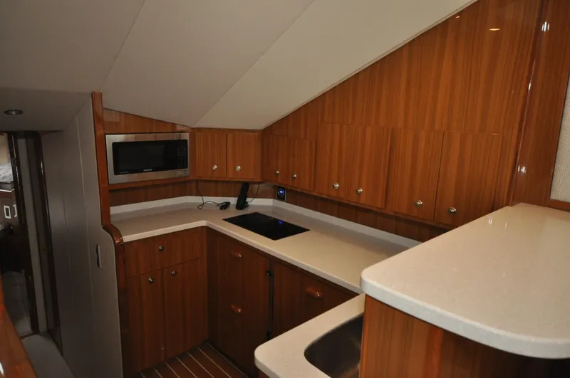  Yacht Photos Pics 2019 Viking 44 Convertible yacht kitchen with wood cabinetry and modern appliances.