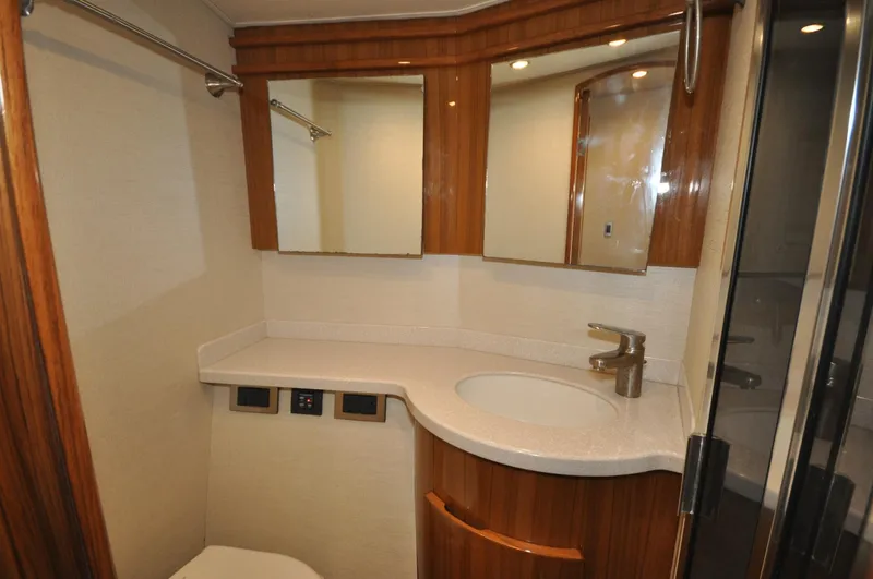  Yacht Photos Pics Luxurious bathroom in 2019 Viking 44 Convertible yacht with modern fixtures and wood accents.