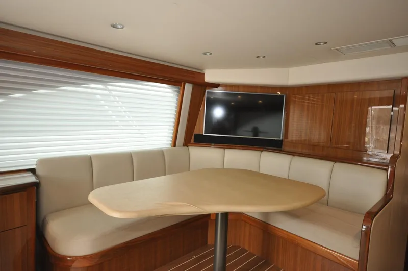  Yacht Photos Pics Luxurious interior of 2019 Viking 44 Convertible yacht with dining area and TV.