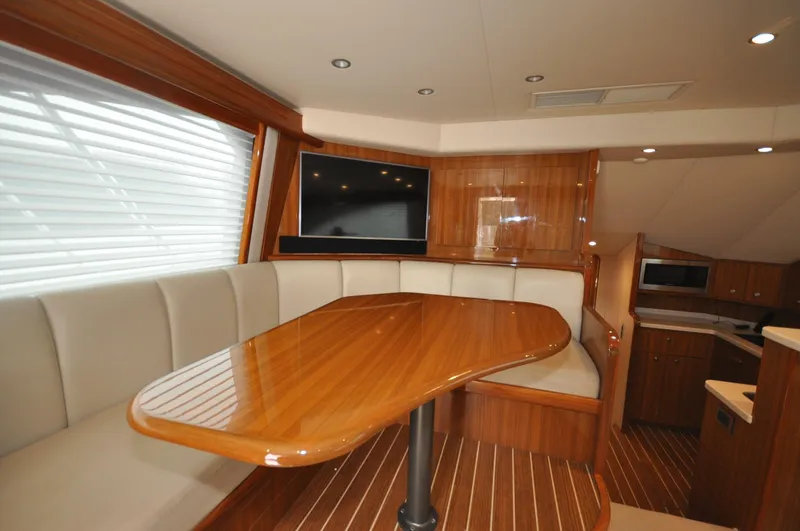  Yacht Photos Pics Luxurious interior of 2019 Viking 44 Convertible yacht with elegant wood finishes and seating.