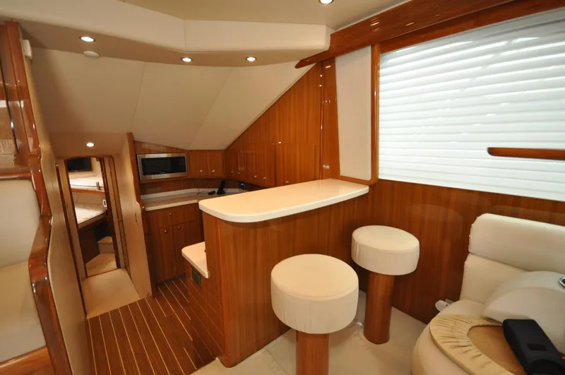  Yacht Photos Pics Luxurious interior of 2019 Viking 44 Convertible yacht with wood finishes and modern seating.