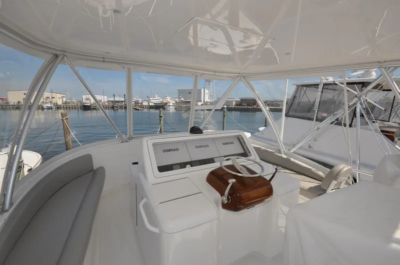 Yacht Photos Pics 2019 Viking 44 Convertible yacht helm with marina view.