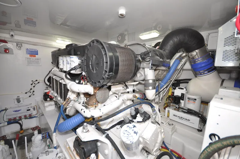  Yacht Photos Pics Engine room of 2019 Viking 44 Convertible yacht, showcasing complex machinery and components.