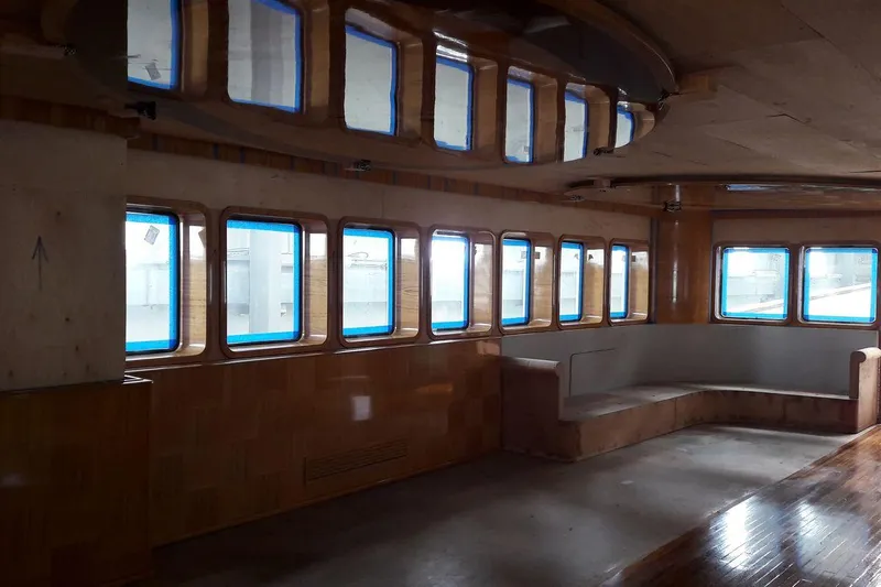 Svetlana (as Is) Yacht Photos Pics Interior of AvA Yachts Svetlana 2027, featuring large windows and wooden seating area.