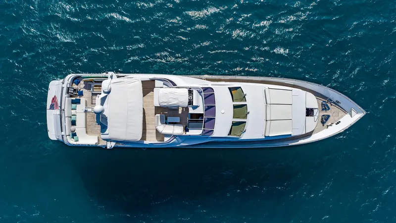  Yacht Photos Pics Aerial view of 1999 Azimut 100 Jumbo yacht cruising on blue ocean waters.
