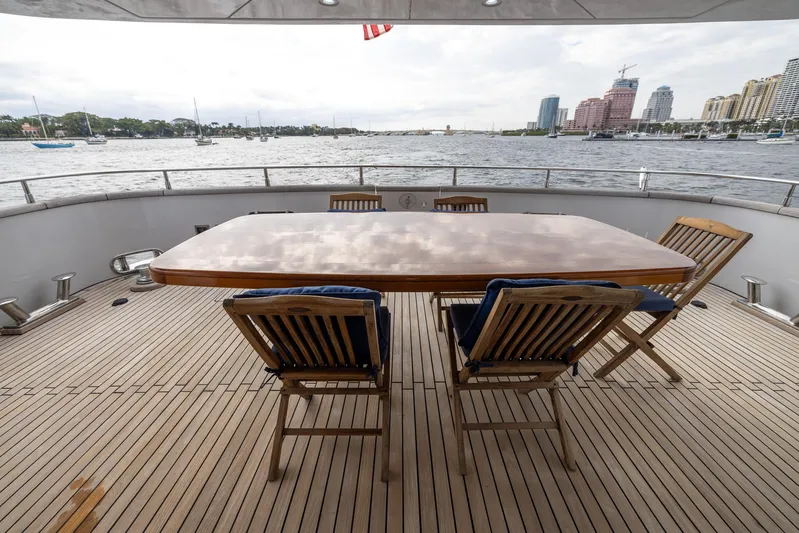  Yacht Photos Pics Deck view of 1999 Azimut 100 Jumbo yacht with wooden table and chairs.