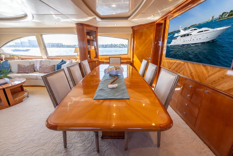  Yacht Photos Pics Luxurious dining area on 1999 Azimut 100 Jumbo yacht with elegant wooden table and sea view.