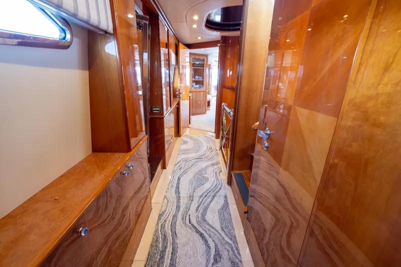 Yacht Photos Pics Luxurious hallway of a 1999 Azimut 100 Jumbo yacht with polished wood finishes.