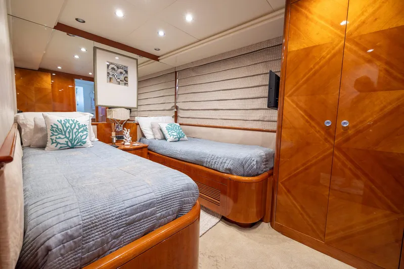  Yacht Photos Pics Luxurious twin cabin on a 1999 Azimut 100 Jumbo yacht with elegant wood finishes.
