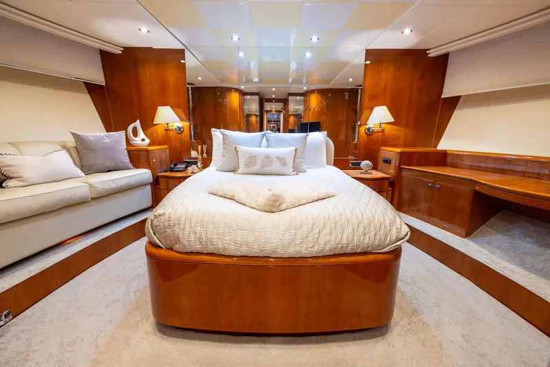  Yacht Photos Pics Luxurious master bedroom on 1999 Azimut 100 Jumbo yacht with elegant wood finishes.