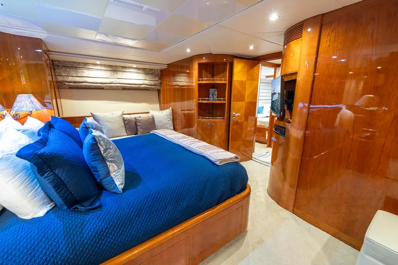  Yacht Photos Pics Luxurious bedroom interior of 1999 Azimut 100 Jumbo yacht with blue bedding.