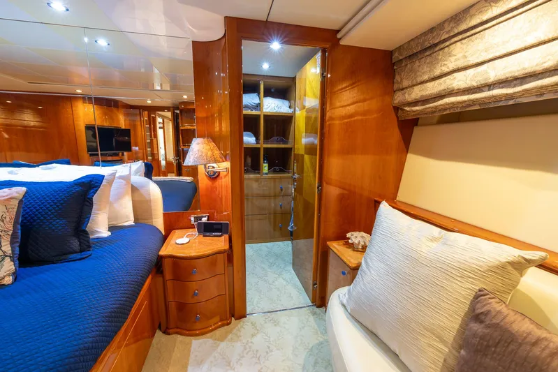  Yacht Photos Pics Luxurious bedroom interior of 1999 Azimut 100 Jumbo yacht with wooden furnishings.